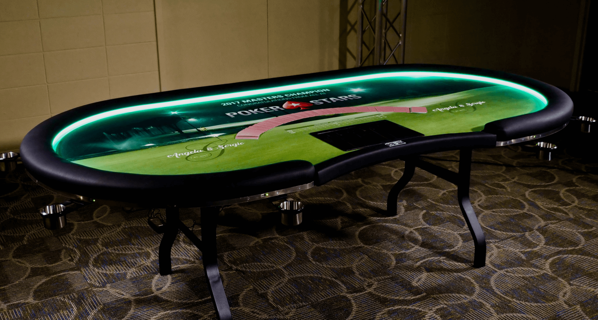 Custom poker table with logo on the top felt and an LED-lit vinyl rail and USB ports.